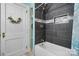 Updated bathroom features a shower with black tiling and a storage niche at 2701 N Main Ave, Newton, NC 28658