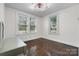 This bright bedroom offers wood floors, two windows, and neutral paint colors at 2701 N Main Ave, Newton, NC 28658