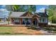 Charming brick house featuring a covered front porch with rocking chairs and well-maintained lawn at 2701 N Main Ave, Newton, NC 28658