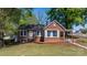 Charming brick home with a well-manicured lawn and mature trees at 2701 N Main Ave, Newton, NC 28658