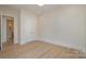 Bright bedroom features double door closet, neutral paint, and light wood floors at 2924 Sharon View Rd # B, Charlotte, NC 28210