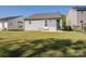 The backyard has a well-maintained lawn and a patio area, perfect for outdoor relaxation and entertaining at 3005 Kansas City Dr, Monroe, NC 28110