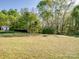 Spacious, well-maintained backyard features a lush lawn with mature trees providing privacy and shade at 3005 Kansas City Dr, Monroe, NC 28110