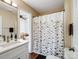 Bright bathroom featuring a modern vanity and a shower-tub combo with a decorative shower curtain at 3005 Kansas City Dr, Monroe, NC 28110