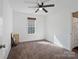 Bright bedroom features a ceiling fan, and neutral carpet, with an adjoining bathroom at 3005 Kansas City Dr, Monroe, NC 28110