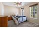 Cozy bedroom with a ceiling fan, large windows, and neutral carpet at 3005 Kansas City Dr, Monroe, NC 28110