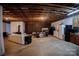 Spacious finished basement with exposed ceiling, wood burning stove, and entertainment area at 3032 Mckinney Rd, Shelby, NC 28152