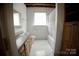 Standard bathroom with vanity, toilet, tub/shower combo, and built-in cabinet at 3032 Mckinney Rd, Shelby, NC 28152