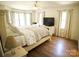 A bedroom with a large bed, ceiling fan and lots of light at 3032 Mckinney Rd, Shelby, NC 28152
