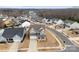 Beautiful aerial view of a gray home nestled in a quiet neighborhood by the lake with mature trees at 3041 Winged Teal Ct, Belmont, NC 28012