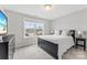 Bedroom with a black bed frame and a view of the neighborhood through the window at 3041 Winged Teal Ct, Belmont, NC 28012