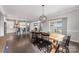 Dining room features hardwood floors, an open concept view to the kitchen, and sliding door access to patio at 3041 Winged Teal Ct, Belmont, NC 28012