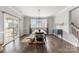 Spacious dining room with natural light, hardwood floors and modern chandelier at 3041 Winged Teal Ct, Belmont, NC 28012