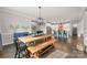 Dining area leading to kitchen with open floor plan, modern chandelier and hardwood floors at 3041 Winged Teal Ct, Belmont, NC 28012
