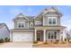 Charming two-story home with a welcoming front porch and a two-car garage, great curb appeal at 3041 Winged Teal Ct, Belmont, NC 28012
