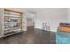 Versatile flex space with hardwood floors and stylish shelving unit at 3041 Winged Teal Ct, Belmont, NC 28012