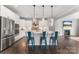 Modern kitchen with white cabinets, stainless steel appliances, and a large center island with pendant lights at 3041 Winged Teal Ct, Belmont, NC 28012