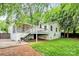 Spacious backyard with patio, lush green lawn, and white house with stairs to back deck at 3510 Conway Ave, Charlotte, NC 28209