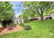 Backyard with a brick patio, trees, and grass at 3510 Conway Ave, Charlotte, NC 28209