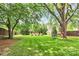 Lush backyard with mature trees and well manicured green lawn at 3510 Conway Ave, Charlotte, NC 28209