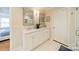 Bathroom featuring dual vanity, white cabinets, and modern fixtures at 3510 Conway Ave, Charlotte, NC 28209
