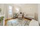Bright Bedroom with white crib, rocking chair, patterned rug, and natural light at 3510 Conway Ave, Charlotte, NC 28209