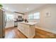 Well-lit kitchen with an island, stainless steel appliances, and tile backsplash at 3510 Conway Ave, Charlotte, NC 28209