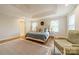 Bright main bedroom boasts a trey ceiling, hardwood floors, and neutral decor at 3510 Conway Ave, Charlotte, NC 28209