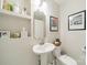 Chic powder room with pedestal sink, stylish fixtures, and elegant decor at 3510 Conway Ave, Charlotte, NC 28209