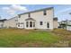 Backyard with green space and a view of the back of the house showing a sunroom at 3619 Grove Creek Pond Sw Dr, Concord, NC 28027