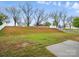 Backyard green space that slopes upward, with a white fence lining the elevated landscape at 3619 Grove Creek Pond Sw Dr, Concord, NC 28027