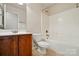 Cozy bathroom with a wood vanity, toilet, and shower-tub combination with tile flooring at 3619 Grove Creek Pond Sw Dr, Concord, NC 28027