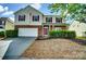 Charming two-story home featuring brick accents, red shutters, well-maintained landscaping, and a two-car garage at 3619 Grove Creek Pond Sw Dr, Concord, NC 28027