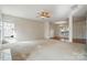 Spacious living room offers lots of natural light, an adjacent dining area and neutral carpet at 3619 Grove Creek Pond Sw Dr, Concord, NC 28027