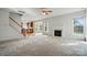 Bright living room with a fireplace, adjacent to the kitchen, features neutral colors and large windows at 3619 Grove Creek Pond Sw Dr, Concord, NC 28027