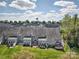 View of townhouse backyards with well-maintained lawns, patios, and deck; perfect for outdoor living and entertaining at 4011 Fenworth Ct, Fort Mill, SC 29715