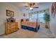 Cozy bedroom with a ceiling fan, window, and a charming dresser, perfect for relaxing and unwinding at 4011 Fenworth Ct, Fort Mill, SC 29715