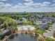 Aerial showcasing community amenities: a pool, a parking lot, and lush landscaping, near homes and a lake at 4011 Fenworth Ct, Fort Mill, SC 29715