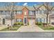 Charming brick townhome featuring a one-car garage, well-maintained landscaping, and a welcoming front entrance at 4011 Fenworth Ct, Fort Mill, SC 29715