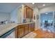 Kitchen featuring granite countertops, wood cabinets and a view into the living room and office space at 4011 Fenworth Ct, Fort Mill, SC 29715