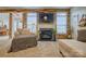Inviting living room with wood accent wall, cozy fireplace, and plush chair with throw blanket at 4011 Fenworth Ct, Fort Mill, SC 29715