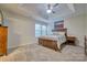 Relaxing bedroom showcasing a tray ceiling, a neutral palette, and an ocean view canvas above the wooden headboard at 4011 Fenworth Ct, Fort Mill, SC 29715