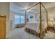Spacious bedroom with a four poster bed, ceiling fan, and large windows that fill the space with natural light at 4011 Fenworth Ct, Fort Mill, SC 29715