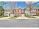 Charming street view of townhouses featuring brick and siding facades, neat landscaping, and attached garages at 4011 Fenworth Ct, Fort Mill, SC 29715