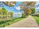 Picturesque walking path next to a serene lake, surrounded by lush greenery and clear blue skies on a sunny day at 4011 Fenworth Ct, Fort Mill, SC 29715