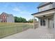 An open-air back porch overlooks a large, flat lawn surrounded by a wooden fence at 4036 Meadowview Hills Dr # 7, Charlotte, NC 28269