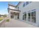 A large back porch with an outdoor fan, lots of windows, and neutral colors on the exterior at 4036 Meadowview Hills Dr # 7, Charlotte, NC 28269