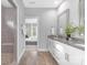 Open-concept bathroom with a double vanity, tiled shower and a view into a bedroom through a connecting door at 4036 Meadowview Hills Dr # 7, Charlotte, NC 28269