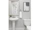 Stylish bathroom with a pedestal sink, round mirror, and a modern toilet, creating a minimalist design at 4036 Meadowview Hills Dr # 7, Charlotte, NC 28269