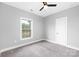 Clean, neutral bedroom with large window and modern finishes at 4036 Meadowview Hills Dr # 7, Charlotte, NC 28269